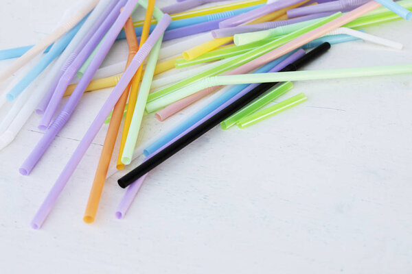 Used straws on white table