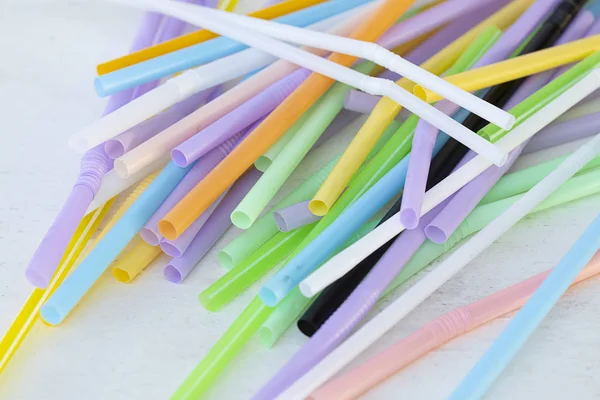 Used straws on white table — ストック写真