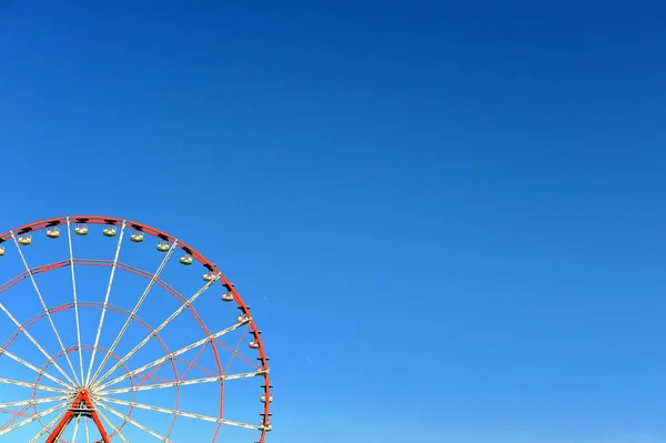 Ferris wheel with sky on background
