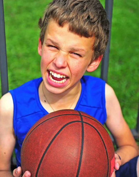 Радісний підліток з баскетболом на відкритому повітрі — стокове фото