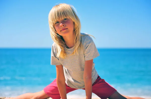 Portrait of blond boy with blue sea and sky — Stock Photo, Image