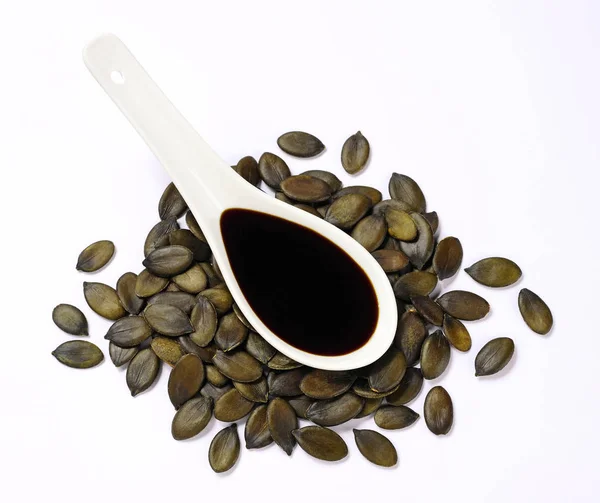Aceite de semilla de calabaza sobre fondo blanco —  Fotos de Stock
