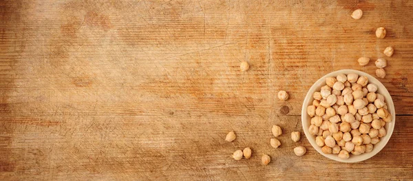 Chickpeas over wooden background — Stock Photo, Image