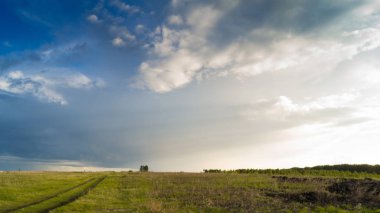 Peyzaj alanı ile bulutlar ve güneş ışınları ile yol ve ağaçlar ve yağmur gök.