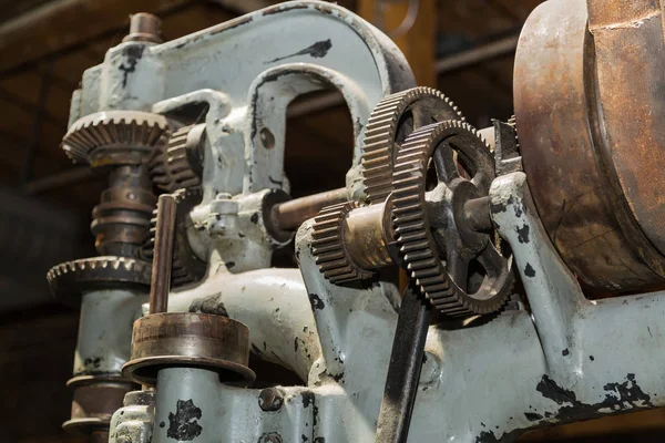 beautiful detailed old vintage machine tool gears and other parts on dark background