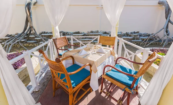 Beautiful inviting closeup view of dinner table inside the outdoor gazebo — Stock Photo, Image