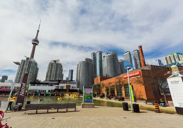 Gorgeous view of various condo and office stylish modern buildings with cn tower behind, against blue cloudy sky background on sunny day — Stock Photo, Image