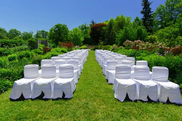 Increíble vista de sillas blancas decoradas en el jardín botánico preparado para un evento de ceremonia de boda —  Fotos de Stock