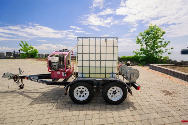 View of a small trailer with plastic box in metal frame and engine mounted on trailer frame, — Stock Photo, Image