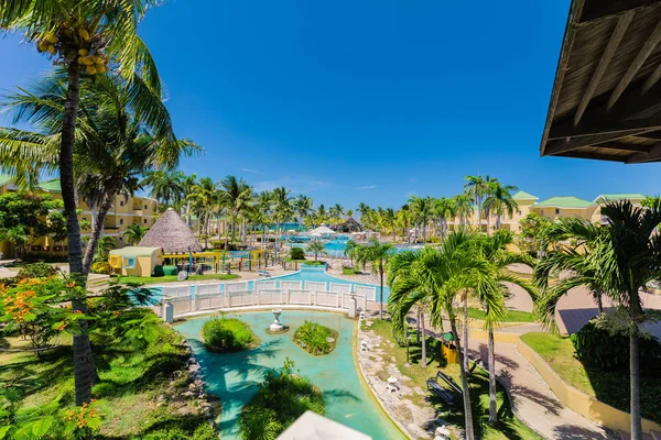 Asombrosa vista atractiva de los jardines del hotel, jardín tropical y varias piscinas con personas relajándose y nadando en el fondo — Foto de Stock