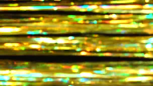 概要黄金を基調としたボケを持つチンセルから水平な光沢のある背景 輝く光と輝く粒子の美しい動的背景 お祭り気分 クリスマスや休日のテーマ — ストック動画