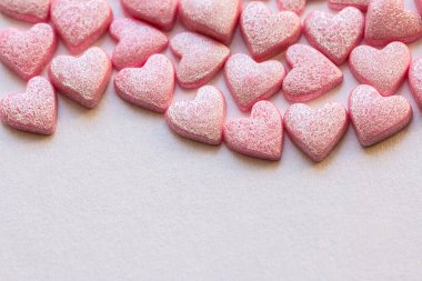 Pink Hearts Shape Candy on pink surfase