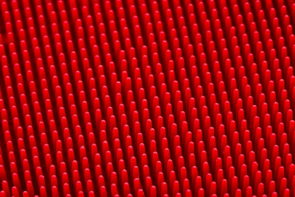 Massagem de silicone vermelho textura de superfície brash close-up para o fundo — Fotografia de Stock