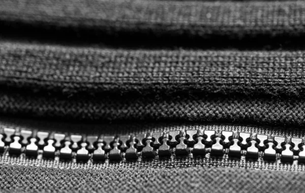 Black  plastic zipper on black knitted fabric. Close up. Macro. — Stock Photo, Image