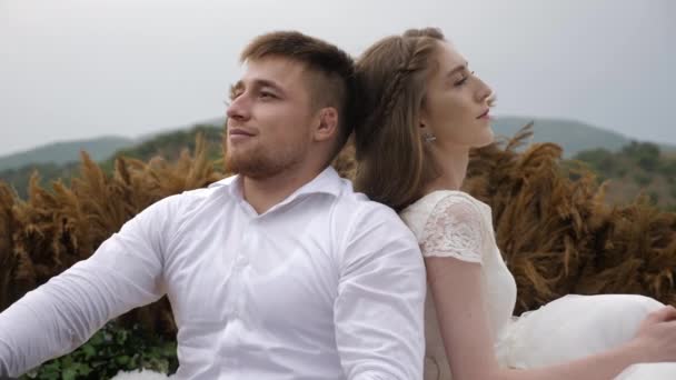 Wonderful wedding couple sits near stylish decorations — 비디오