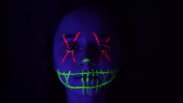 Young woman with scary orange and green neon makeup macro — Wideo stockowe