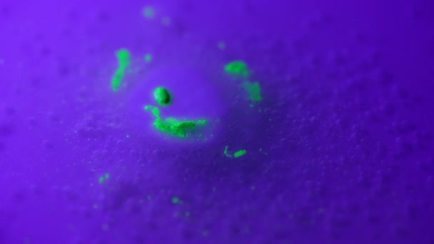 Green coloured neon smile on tablet dissolves in water — Stockvideo