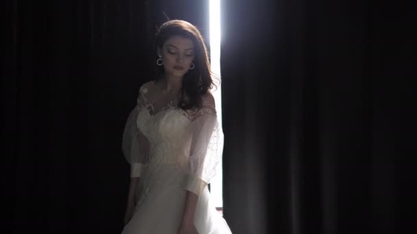 Long haired bride poses against curtains clearance in studio — Stock Video