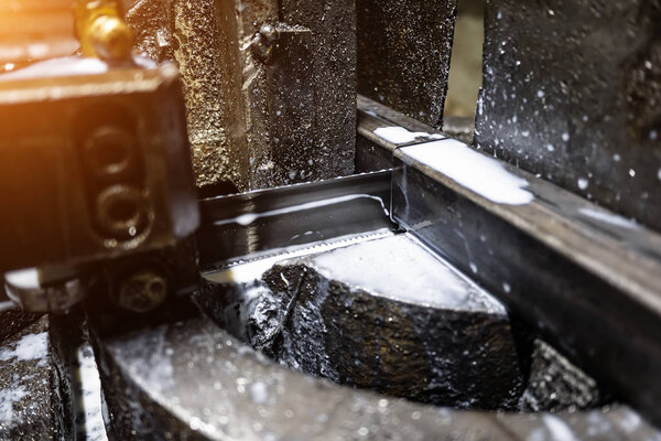 Industrial CNC lathe with band saw for cutting metal products. 