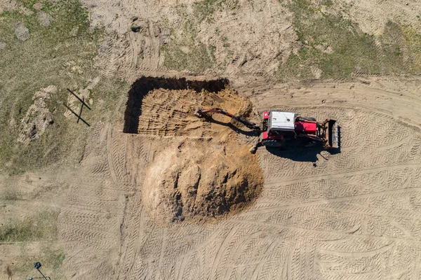 an excavator digs a hole on a construction site