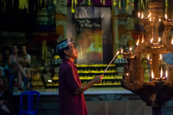 Man lighting candles at a kecak fire dance ceremony, Ubud, Bali, — Stockfoto