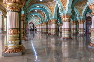 Mysore, India - March 10, 2018: Audience hall of the Mysore Palace with some visitors in the background