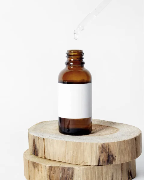 Brown glass skin care bottle decorate with wood on white background photo