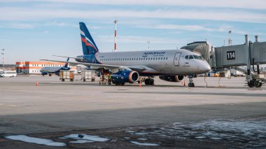 Moscow / Russia - March 16 2020: Sukhoi Superjet 100 Aeroflot at the gate of Sheremetyevo Airport, Terminal B. clipart