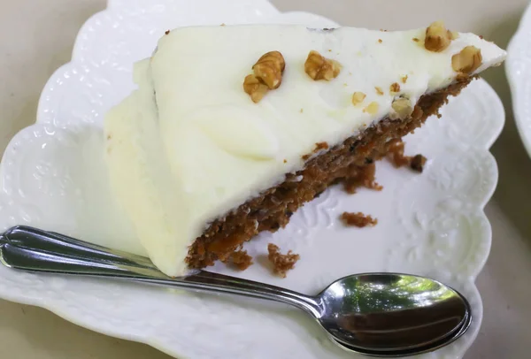 Closeup of Carrot Cake with walnut on white plate