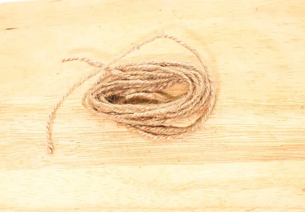 Closeup of small brown rope sack on brown wooden — Stock Photo, Image