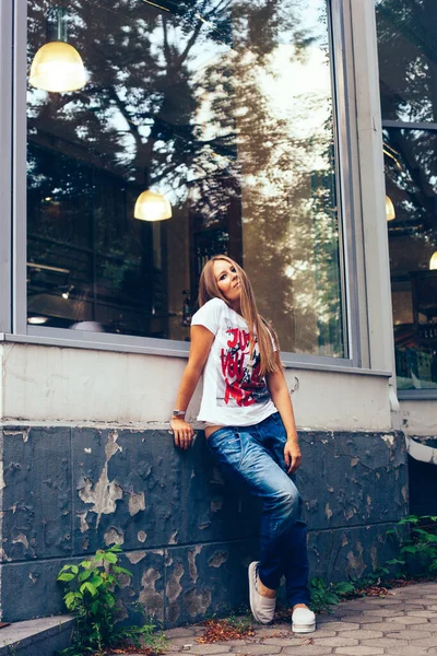 Menina aparência europeia na cidade, estilo urbano, jeans, t-shirt, cabelo longo, verão — Fotografia de Stock