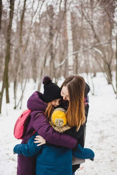 Mother hugs her children, daughter and son, sister and brother, family, walk in the winter forest — 스톡 사진