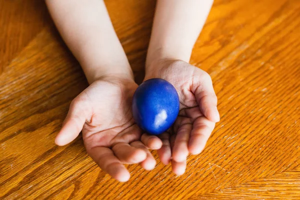 Easter egg in hand, painted eggs, religious holiday, rabbit and find the egg