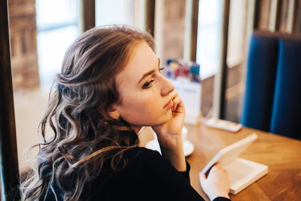 The girl in the cafe, a student or a Manager, meeting with friends in cafes, coffee, and coffee break