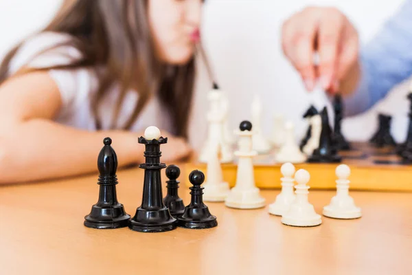 Girl and dad play a game at home, chess, puzzle for brain development, mental intelligence, child development, school, home, quarantine, vacation, time with family