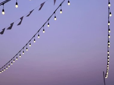Soft focus light bulbs that decorate during celebrations or festivals on a Evening sky background. Holiday decorations. Selective focus