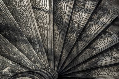 Bangkok, Thailand - Oct 05, 2019 : Upside view of a spiral staircase pattern. Spiral stairs circle in old cozy courtyard architecture. House ladder decoration interior. Architectural element of a historic building. Close-up. Selective focus.