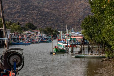 Prachuap khiri khan,Thailand - Mar 01, 2020 : The wooden fishing boats and fisherman bangpu village at Sam Roi Yot District. Selective focus.