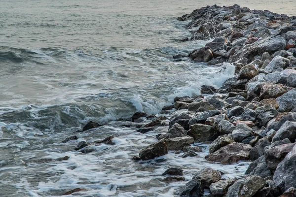 Rocks and sea : View of sea waves hitting rocks on the Calm beach in the morning. No focus, specifically.