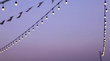 Soft focus light bulbs that decorate during celebrations or festivals on a Evening sky background. Holiday decorations. Selective focus