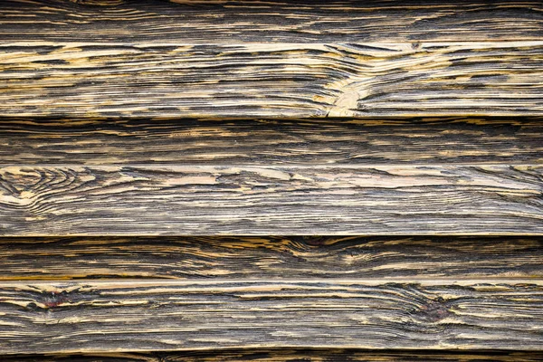 Aged wood texture. Boards are black and brown. Artificially aged wood. Deep texture. The concept of an old tree.