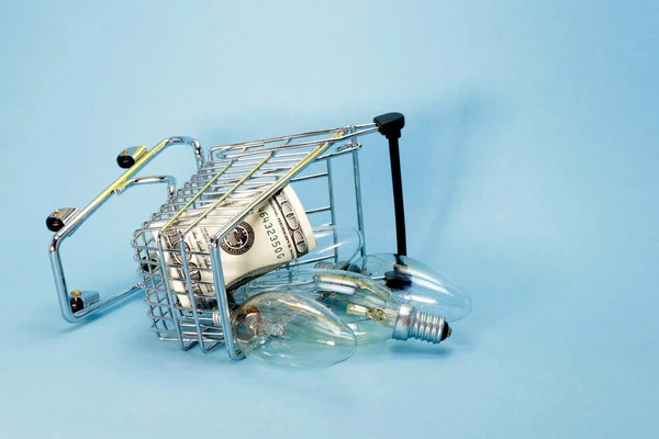 Dumped Trolley Store Dollars Scattered Light Bulbs Concept Energy Conservation — Stock Photo, Image
