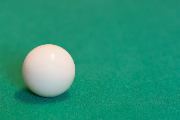 Pool ball on green baize table