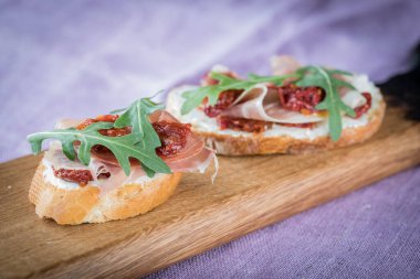 Bruschetta with tomato and basil, bruscetta with salmon and eggs, bruscetta with prosceutto and rucola