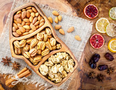 Set of dried fruits and nuts, cheese board and meat board on wooden background