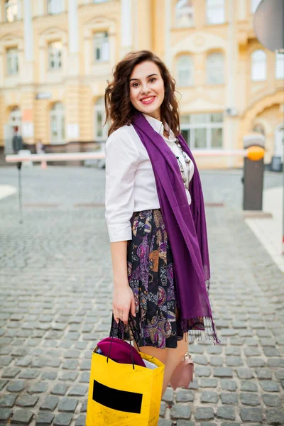 A young girl walks around the city.