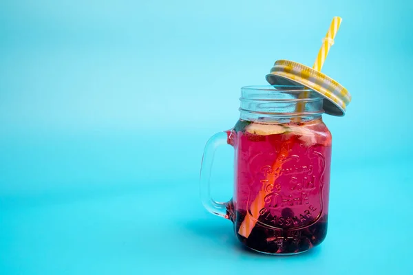 Uma Bebida Refrescante Bagas Limão Copo Com Boné Fundo Azul — Fotografia de Stock