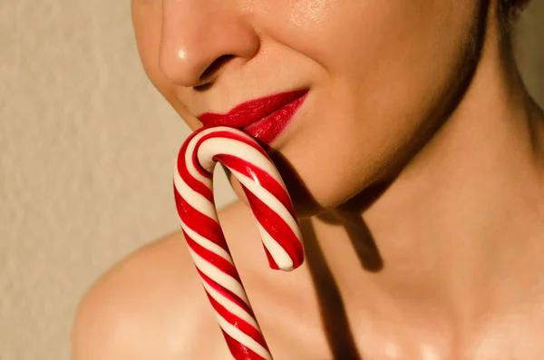 woman with christmas striped candy stick