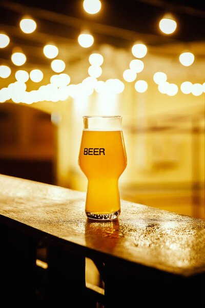 A glass of kraft beer on the background of lanterns