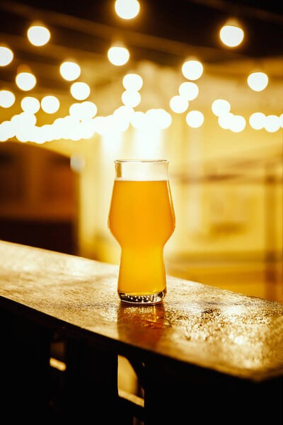 A glass of kraft beer on the background of lanterns